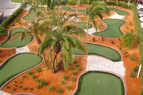 Flagstaff Aerial view of a mini golf course with synthetic grass and palm trees.